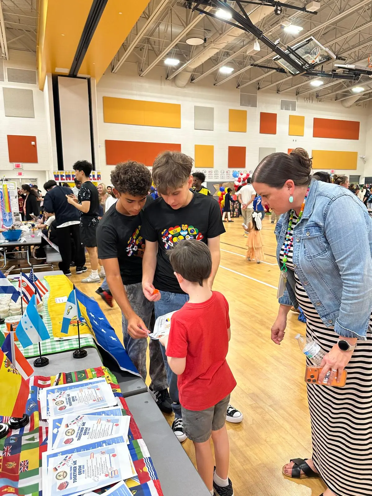 Club members sharing academic information with a young child and an adult at the table