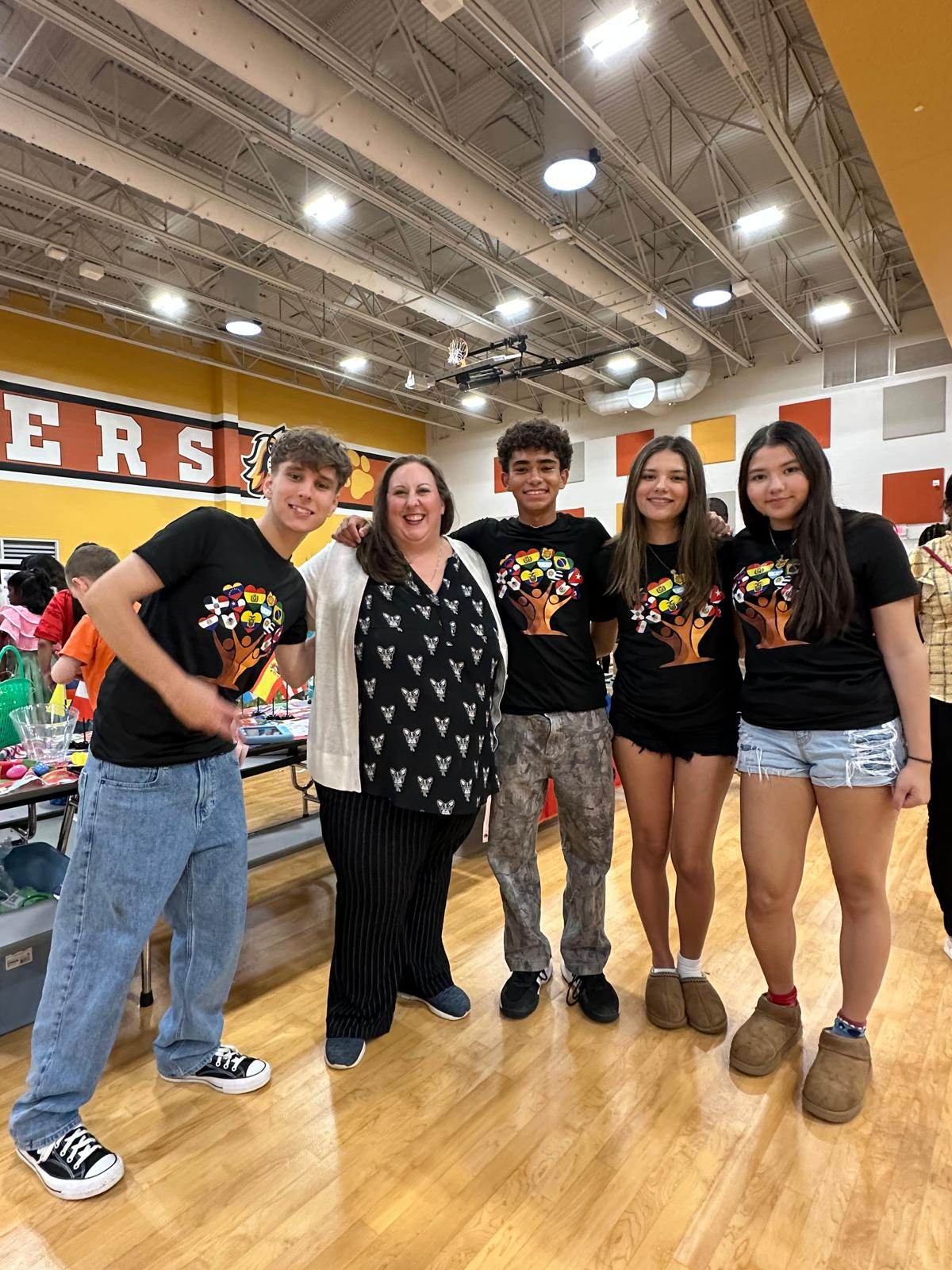 Club members with an educator at the Cross Elementary community event