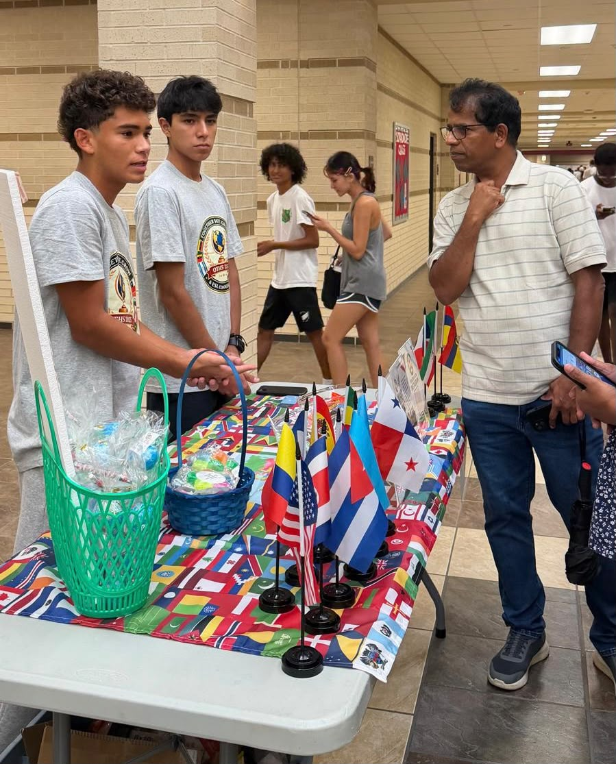 Club members speaking with a community member at the Club Expo table