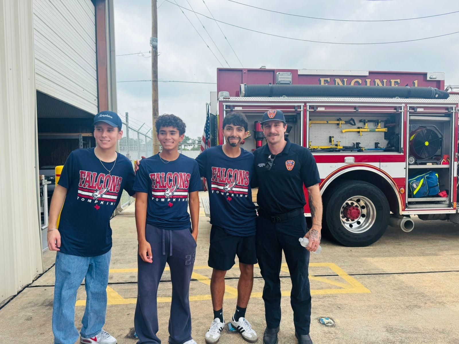 Club members with a firefighter in front of a fire truck at the American Legion Post 164 event
